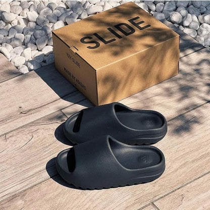 outdoor lifestyle image of the yeezy slide onyx with box